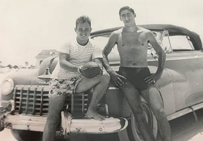 two guys sitting on the car