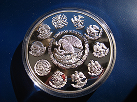silver coin with 10 coats of arms surrounding a center one