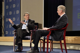 Bill Gates and Francis Collins sitting on stage