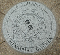 large granite medallion set in the pavement in the garden