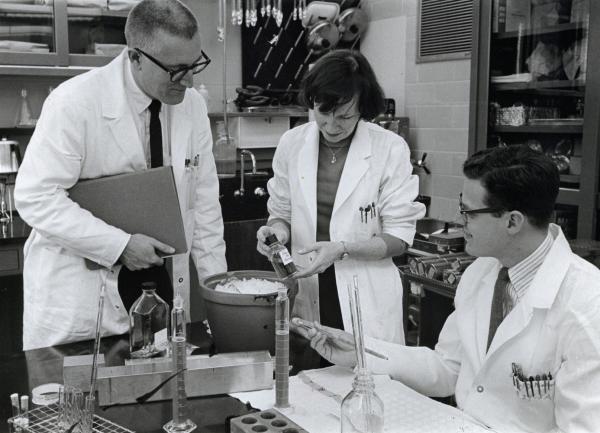 Dr. Meyer (left) and Dr. Parkman (right), along with fellow NIAID scientist Hope Hopps, inspect a culture of the virus that causes rubella