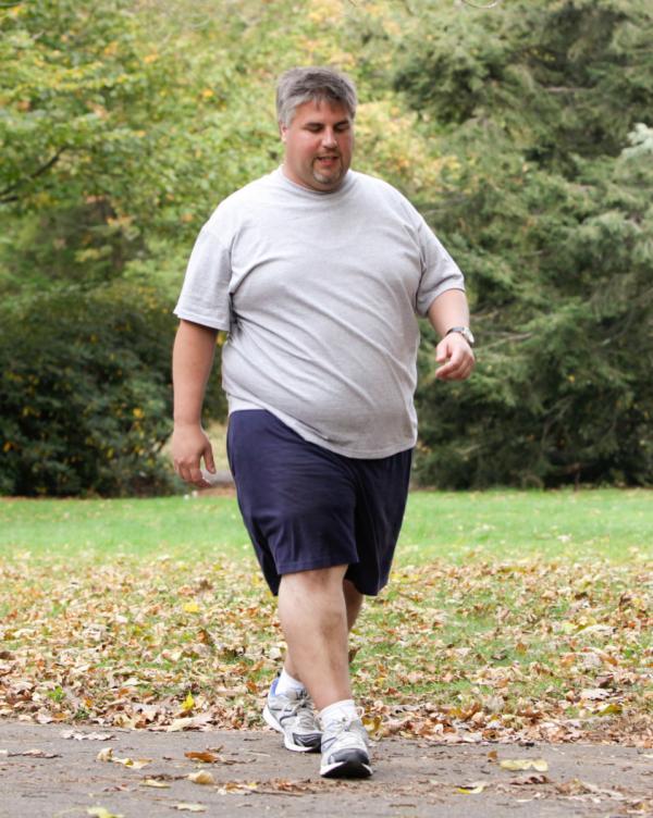 a man with obesity walking in the park