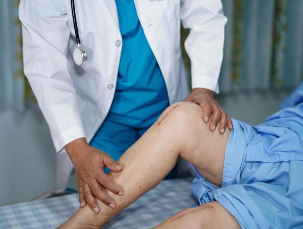 doctor examining knee after surgery