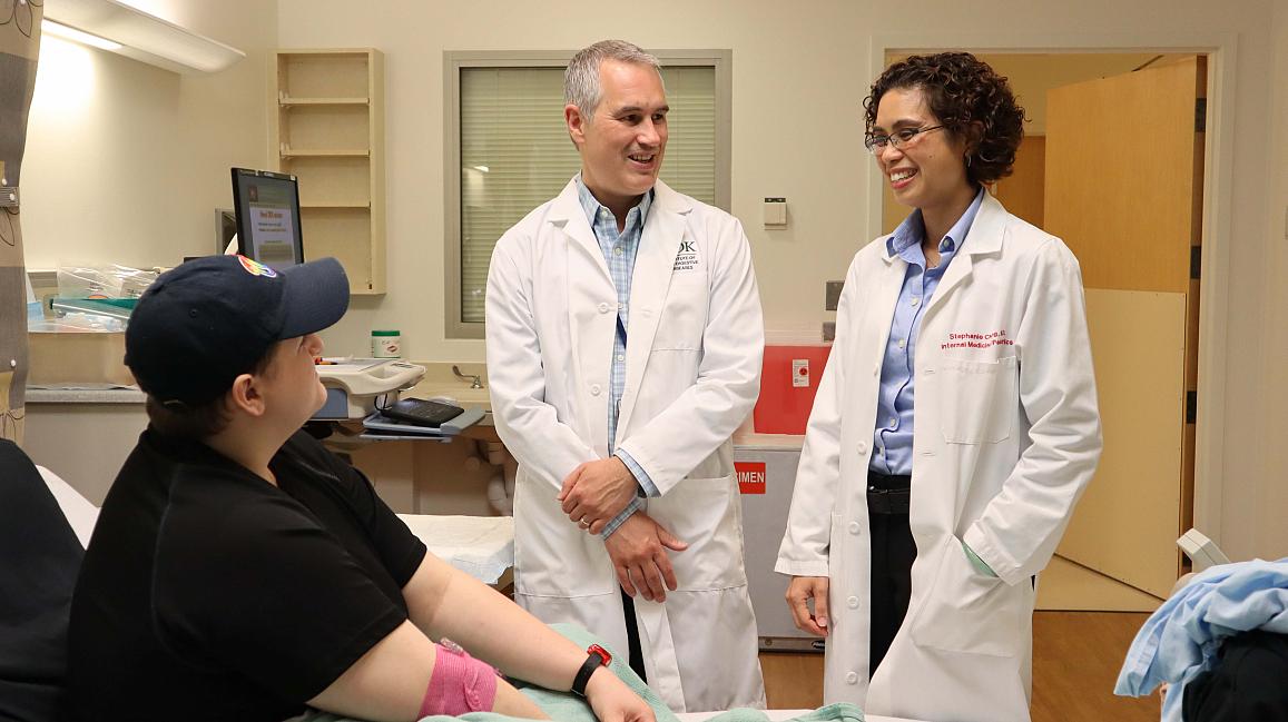 Researchers from the National Institutes talk with a study participant at the NIH Clinical Center