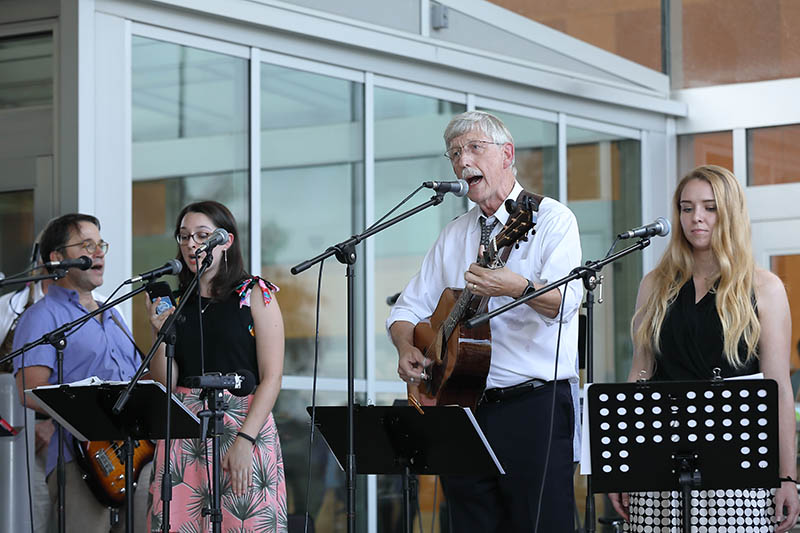 Francis Collins playing guitar with his band.