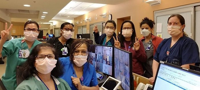 Nurses at the NIH Clinical Center posed for a quick photo during an evening huddle