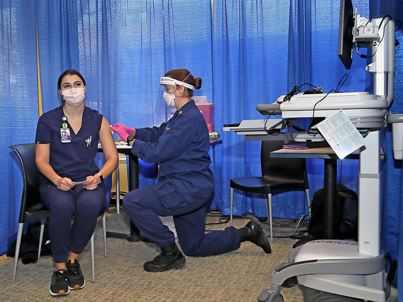 an NIH staff member getting vaccinated against COVID-19