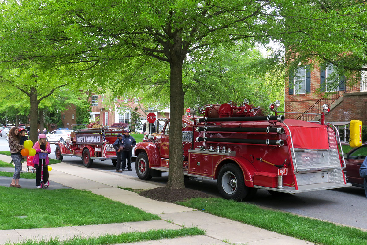 fire truck driving by a birthday party