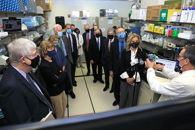 Dr. Francis Collins and Dr. John Mascola with a group of U.S. congresspeople and staffers