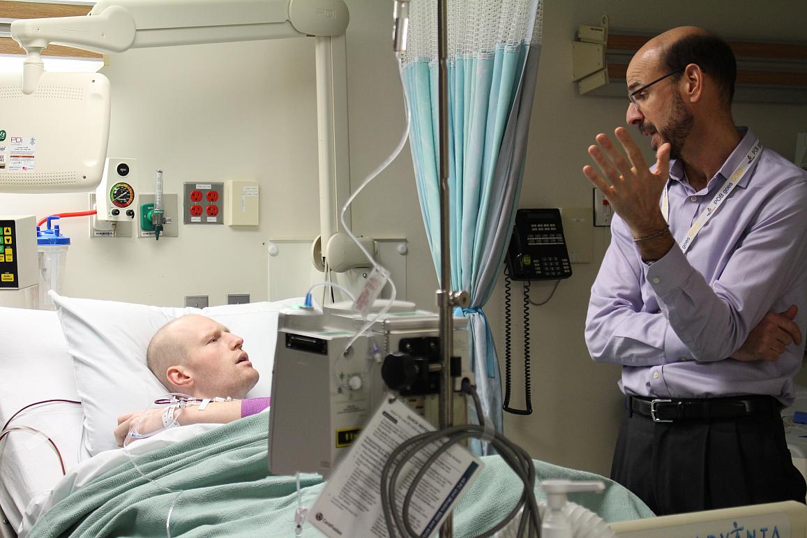 Dr. Terry Fry, Head of the Hematologic Malignancies Section at the National Cancer Institute, discusses immunotherapy treatment with research participant Bo Cooper.&nbsp;