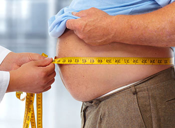 doctor measuring an overweight patient's waist circumference