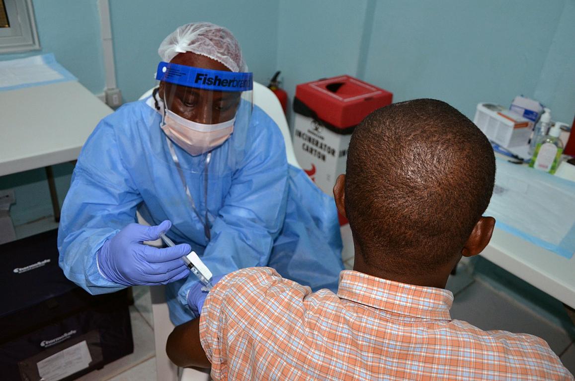 A volunteer receives an injection in the PREVAIL Ebola vaccine clinical trial in Liberia.