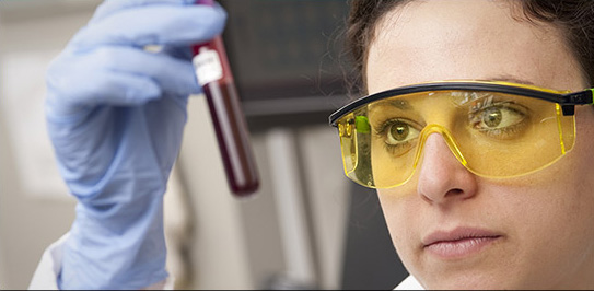 female scientist examining a blood sample