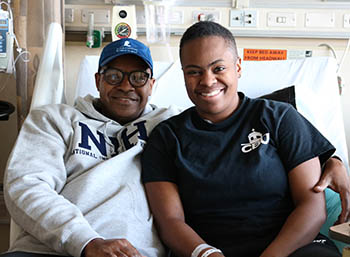 Jahleel's dad and Jahleel, both smiling, in a hospital room.