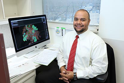  Jason Collins at his desk with computer screen in background