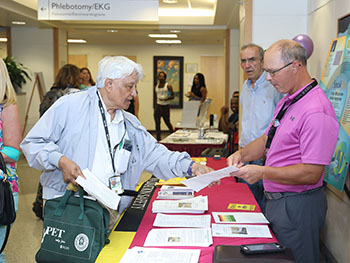 people at exhibit tables