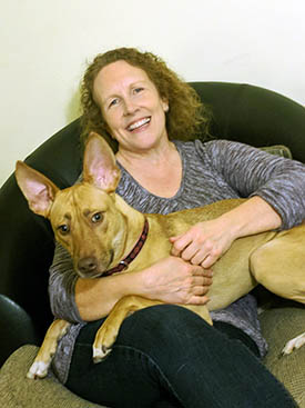 Heidii Parker and her large dog sitting across her lap