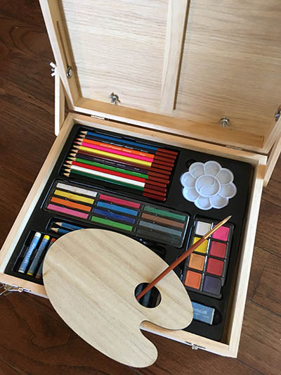 art supplies in an open wooden box