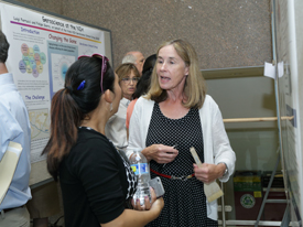 poster session with people talking in front of their posters