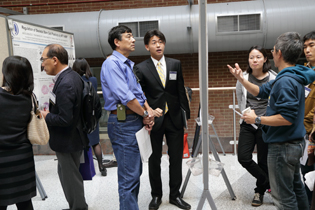 people examining posters at the post session