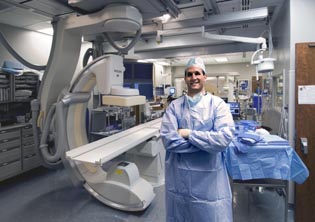 Brad Wood in the interventional radiology suite next to a big imaging machine