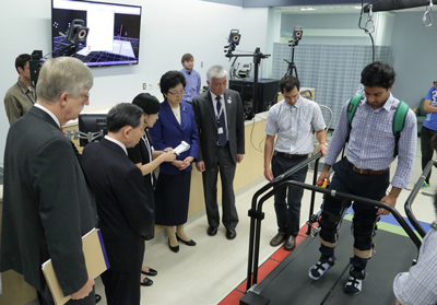 man on a treadmill with others watching