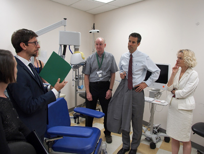 Scientists explaining research to a congressman who is visiting NIH