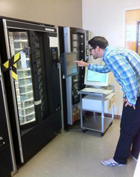 man pushing button on vending machine