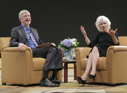 Francis Collins and Diane Rehm laughing on stage