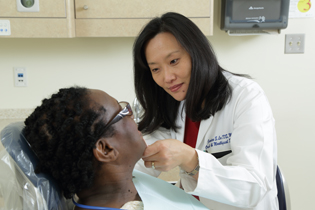 Janice Lee examining a dental patient