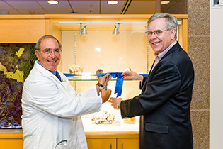 John Gallin and Jeffrey Post cutting the ribbon for the exhibit