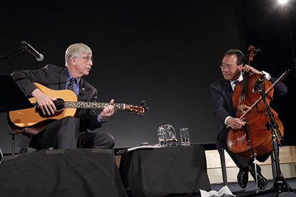 Francis Collins playing guitar and Yo-Yo Ma playing his cello.