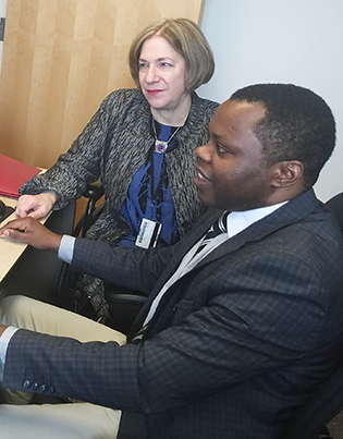 Anne Sumner and Jean Utumatwishima at a desk together