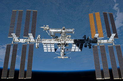 International Space Station in flight against blue background