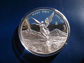 silver coin with winged angel