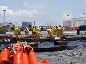 penmen working on the docks cleaning up the oil dispersants