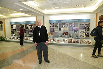 Hank Grasso standing in front of the exhibits.