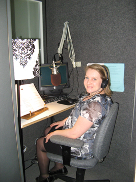 young woman in a recording studio wearing headphones