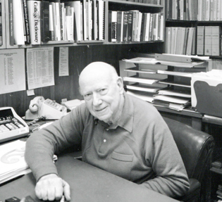 EARL STADTMAN AT HIS DESK