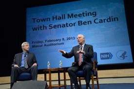 Francis Collins and Ben Cardin sitting on stage.