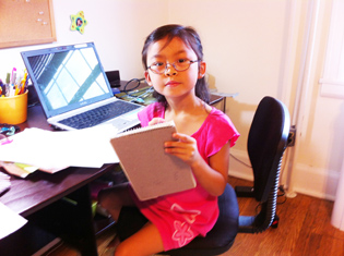  Five-year-old Lin Wanjek-Yasutake with a notebook
