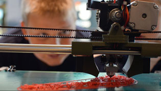 3-D printer making ecoli while a little boy looks on