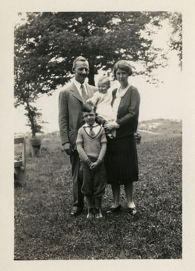  man, woman holding baby, small boy