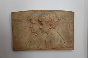 Bas-relief on stone of two boys in profile