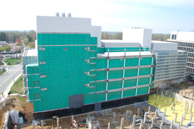 BUILDING ONE WITH GREEN SIDING ON WALL FACING CONSTRUCTION SITE FOR BUILDING TWO