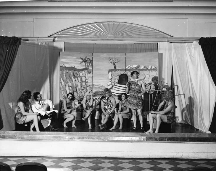 stage with people in costume performing a play