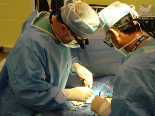  two surgeons performing an operation