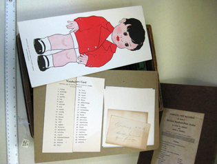 card with illustration of little boy; vocabulary test; other items