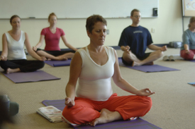 yoga class with people sitting in the lotus position