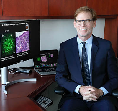 Bruce Tromberg sitting in his office